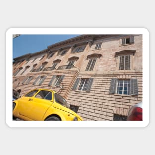 Bright yellow classic Fiat 500 in Italian street. Sticker